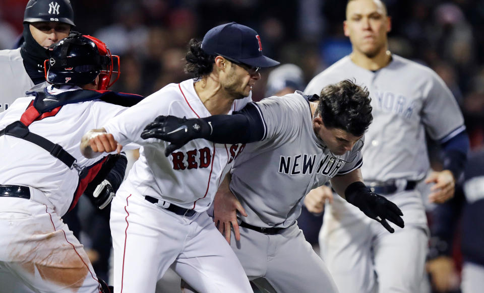 Boston Red Sox relief pitcher Joe Kelly (left) knocks down the Yankees' Tyler Austin as they fight during the seventh inning on Wednesday. (AP)