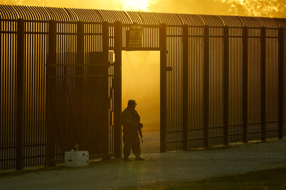 FILE - A National Guardsman stands guard at a fence that runs along the Rio Grande near the International bridge in Del Rio, Texas, Sept. 17, 2021. A year into the Joe Biden’s presidency, though, action on the immigration system has been hard to find and there is growing consternation privately among some in the party that the Biden administration can’t find the right balance on immigration. (AP Photo/Eric Gay, File)