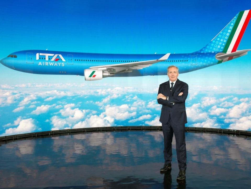 ITA Airways Chairman Alfredo Altavilla poses with rendering of new livery