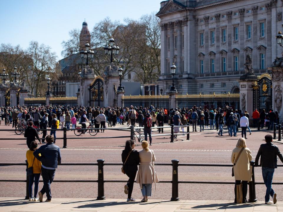 People observe a minute's silence outside Buckingham Palace, LondonPA