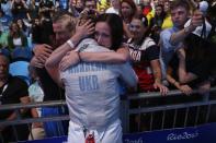 <p>Olga Kharlan of Ukraine embraces friends and family after winning the bronze medal following her bout against Manon Brunet of France during the Women’s Individual Sabre Bronze Medal Bout on Day 3 of the Rio 2016 Olympic Games at Carioca Arena 3 on August 8, 2016 in Rio de Janeiro, Brazil. (Photo by Patrick Smith/Getty Images) </p>