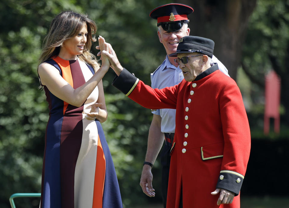 US First Lady Melania Trump, high-fives with a Chelsea Pensioner as she tries her hand at bowls during a visit to the Royal Hospital, Chelsea, London.