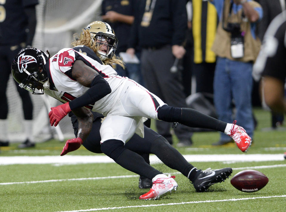 Atlanta Falcons wide receiver Julio Jones (11) fumbles as he is hit by New Orleans Saints middle linebacker Alex Anzalone in the first half of an NFL football game in New Orleans, Thursday, Nov. 22, 2018. (AP Photo/Bill Feig)
