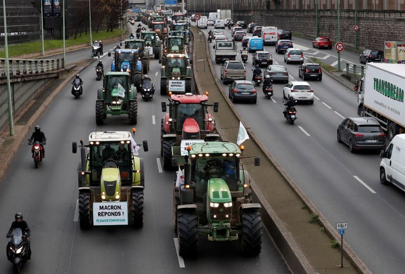 French farmers drive their tractors along the ring road in Paris during a day of protest