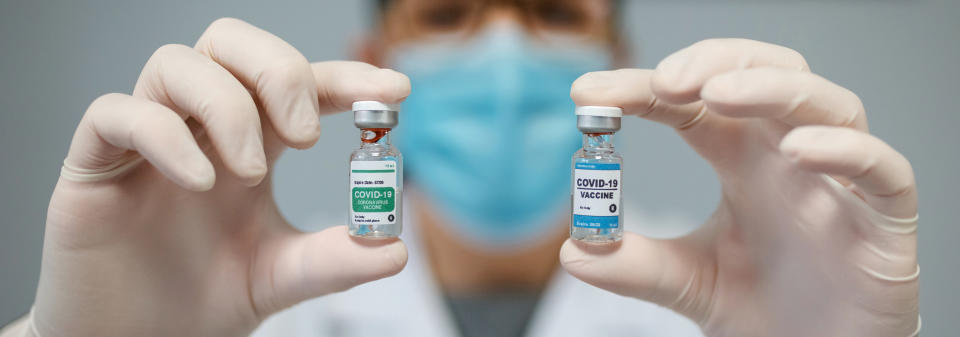 Female doctor showing two coronavirus vaccine options