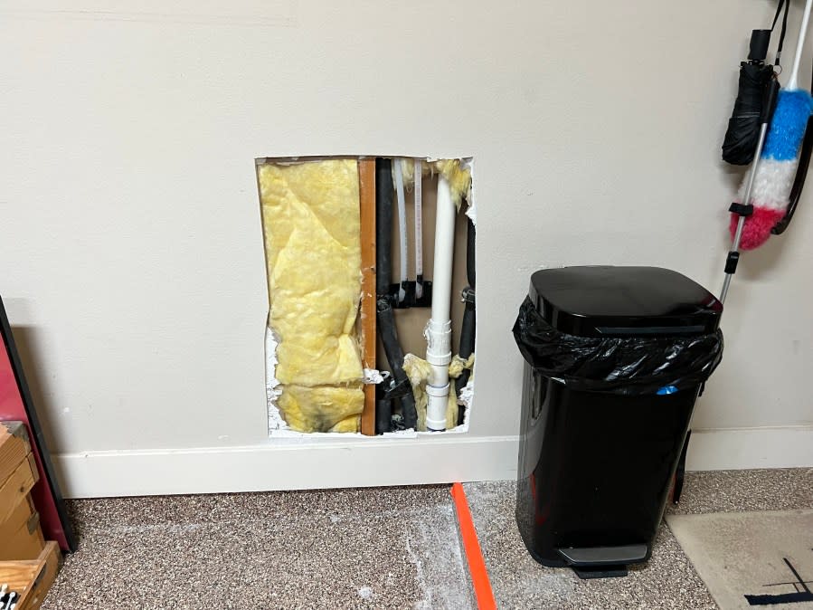 Exposed plumbing can be seen from cut-outs in Perry's house (KXAN Photo/Mike Rush)