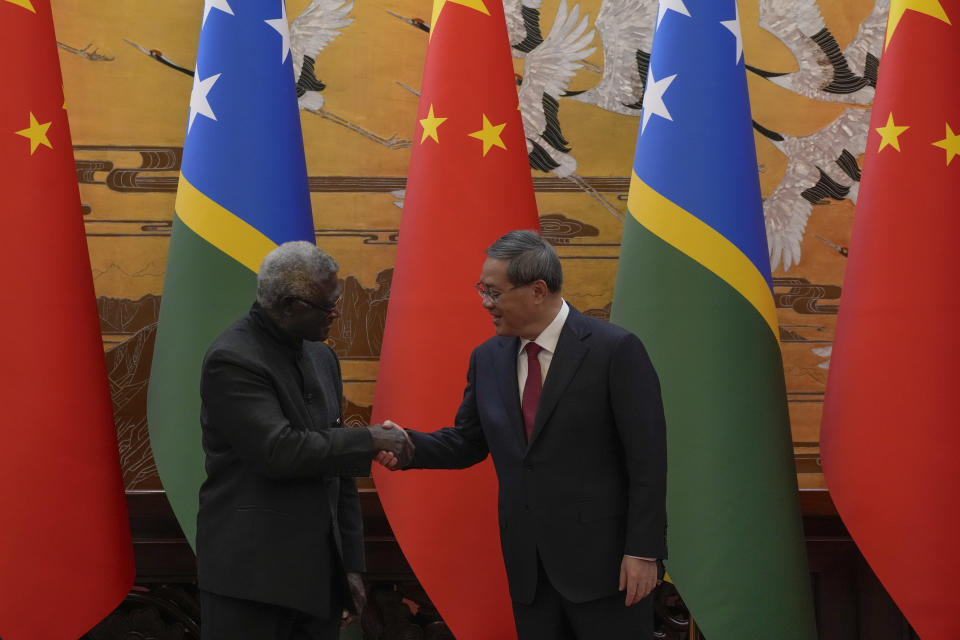 Visiting Solomon Islands Prime Minister Manasseh Sogavare, left, shakes hands with his Chinese counterpart Li Qiang after they witnessed signing on agreement for both countries at the Great Hall of the People in Beijing, Monday, July 10, 2023. (AP Photo/Andy Wong, Pool)