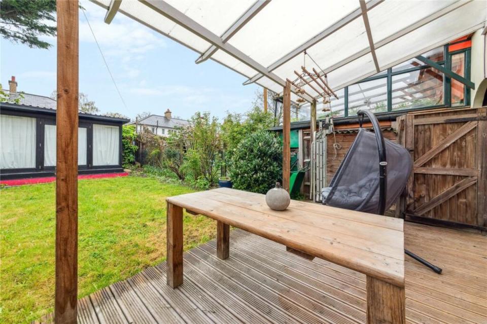 The garden has a covered deck and a separate studio building (Rightmove)