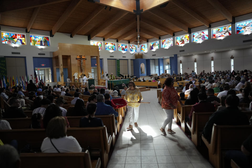 Volunteers collect contributions during Mass at St. Agatha Catholic Church, which has become the spiritual home of the growing Nicaraguan diaspora, Sunday, Nov. 5, 2023, in Miami. For the auxiliary bishop of Managua, one of his concelebrant priests and many in the pews who have had to flee or were exiled from Nicaragua recently, the Sunday afternoon Mass at the Miami parish is not only a way to find solace in community, but also to keep pushing back against the Ortega regime's violent suppression of all critics, including many Catholic leaders. (AP Photo/Rebecca Blackwell)