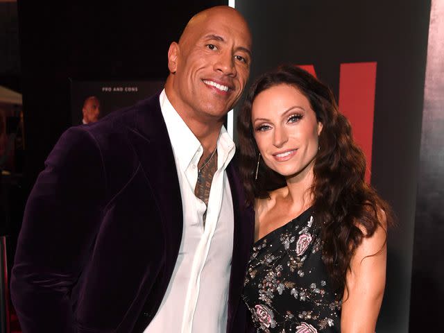 <p>Kevin Mazur/Getty</p> Dwayne Johnson and Lauren Hashian at the World Premiere of Netflix's 'Red Notice' in November 2021.