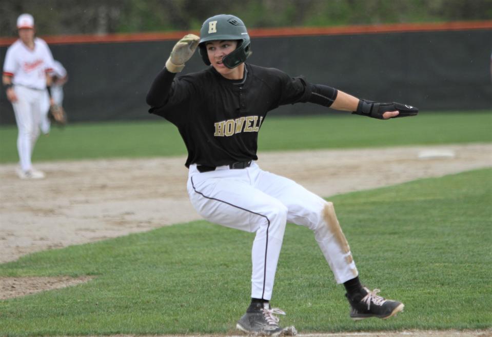 Howell's Nick Hoorn puts on the brakes and retreats to third base during a 12-2 victory over Brighton on Monday, May 8, 2023.