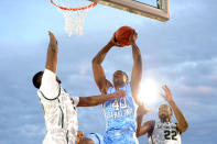 SAN DIEGO, CA - NOVEMBER 11: Harrison Barnes #40 of the North Carolina Tar Heels goes up for a shot against Derrick Nix #25 and Branden Dawson #22 of the Michigan State Spartans in the first half during the NCAA men's college basketball Carrier Classic aboard the flight deck of the USS Carl Vinson on November 11, 2011 in San Diego, California. (Photo by Harry How/Getty Images)