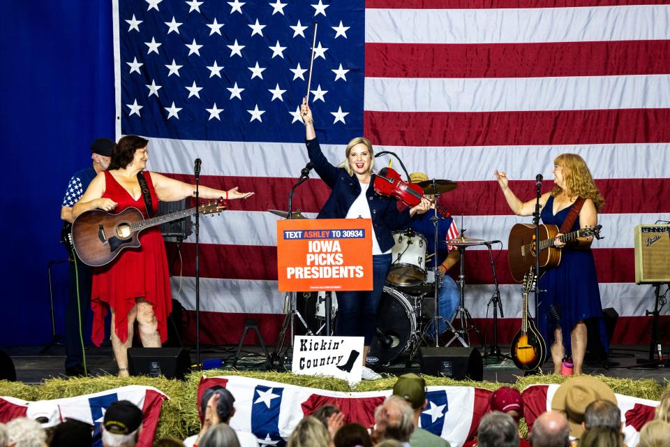 U.S. Rep. Ashley Hinson, R-Iowa, center holding hand up, performs with the Kickin' Country band during the Ashley's BBQ Bash fundraiser, Sunday, Aug. 6, 2023, at Hawkeye Downs in Cedar Rapids, Iowa.