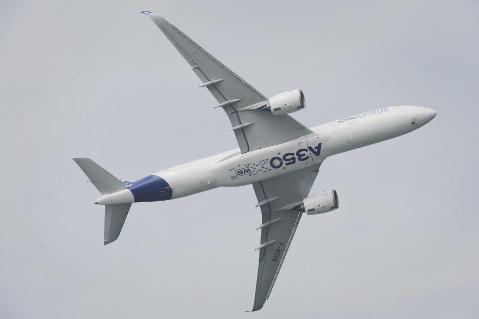 An Airbus A350-900 flies during an aerial display for a media preview ahead of the upcoming Singapore Air Show on Sunday, Feb. 9, 2014. (AP Photo/Joseph Nair)