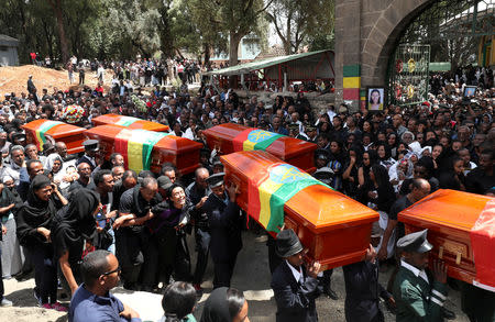 Pallbearers carry the coffins of the victims of the Ethiopian Airline Flight ET 302 plane crash, during the burial ceremony at the Holy Trinity Cathedral Orthodox church in Addis Ababa, Ethiopia, March 17, 2019. REUTERS/Tiksa Negeri