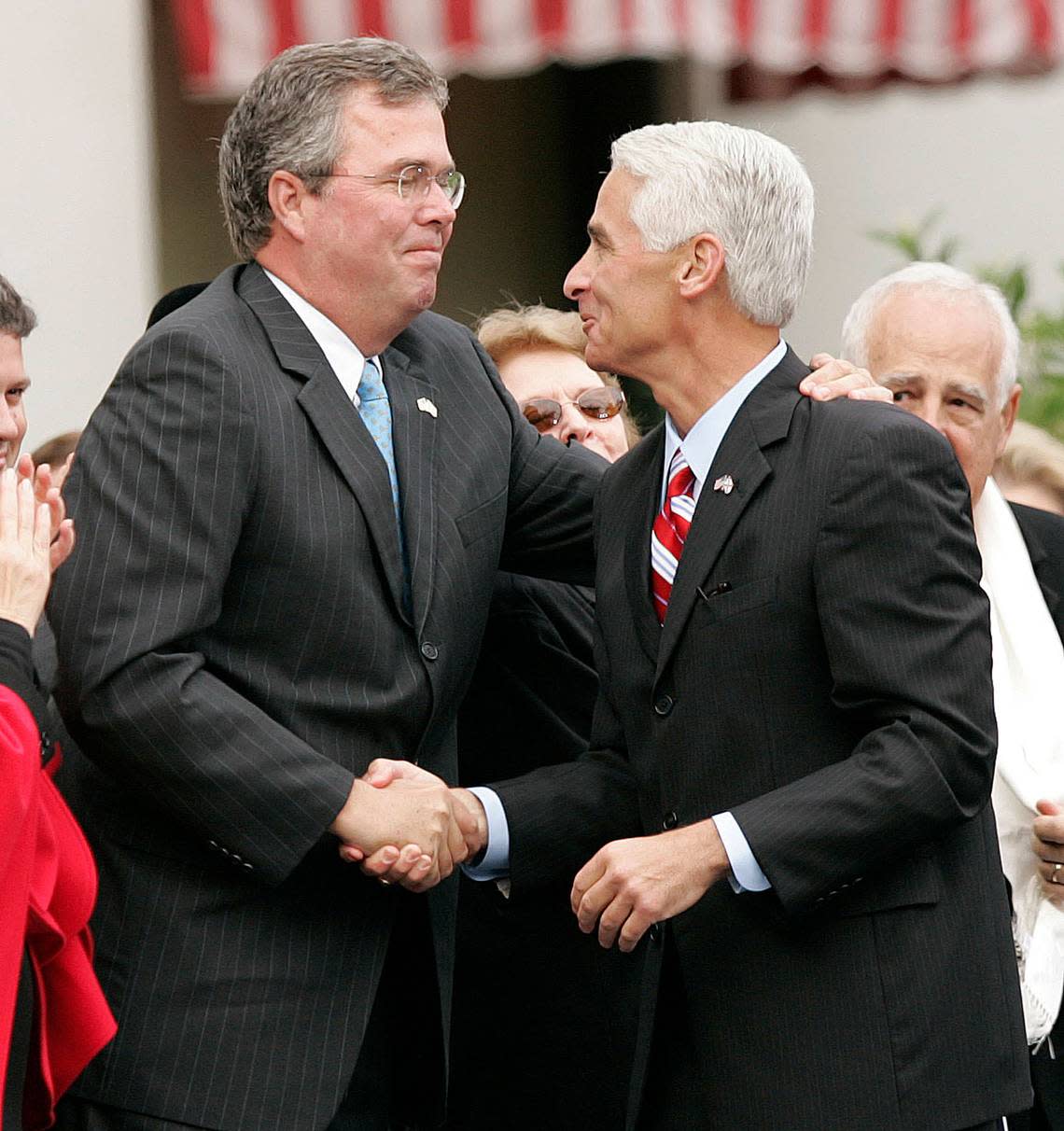 Gov. Jeb Bush, left, greets Gov.-elect Charlie Crist, prior to Crist’s being sworn in as Florida’s 44th governor Tuesday, Jan. 2, 2007, in Tallahassee, Fla.