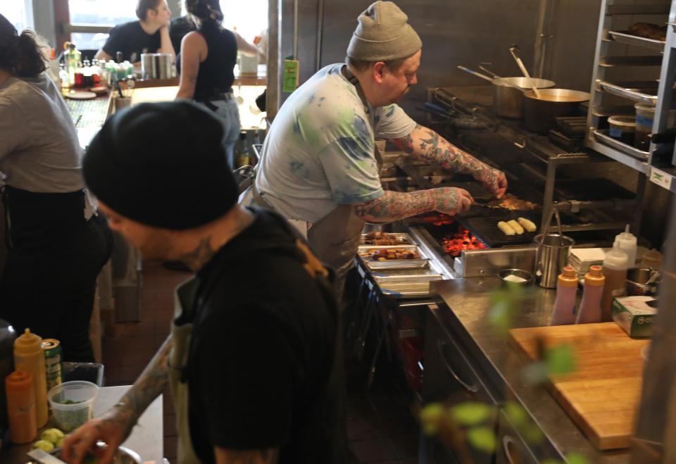 Chef Nevin Price-Meader rotates skewers at Leonore's.