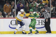 Nashville Predators left wing Kiefer Sherwood (44) and Minnesota Wild center Mason Shaw (15) fight during the first period of an NHL hockey game Sunday, March 10, 2024, in St. Paul, Minn. (AP Photo/Stacy Bengs)