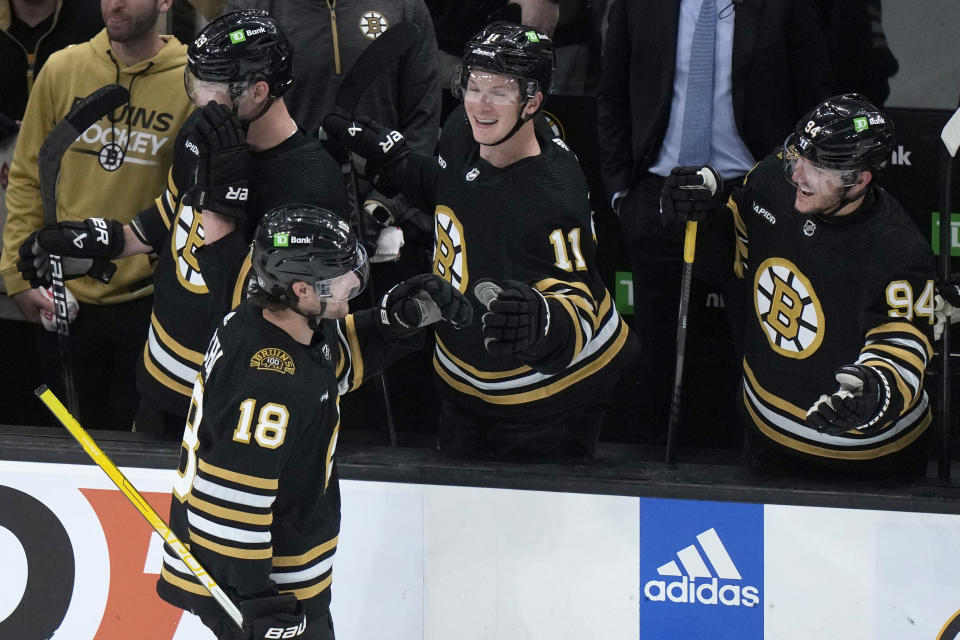 Boston Bruins center Pavel Zacha (18) is congratulated after scoring against the Vancouver Canucks during the second period of an NHL hockey game Thursday, Feb. 8, 2024, in Boston. (AP Photo/Steven Senne)