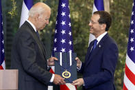 President Joe Biden receives the Israeli Presidential Medal of Honor from Israeli President Isaac Herzog, Thursday, July 14, 2022, in Jerusalem. (AP Photo/Evan Vucci)