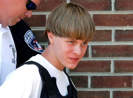 Police lead suspected shooter Dylann Roof into the courthouse in Shelby, North Carolina, U.S., June 18, 2015. REUTERS/Jason Miczek/File Photo