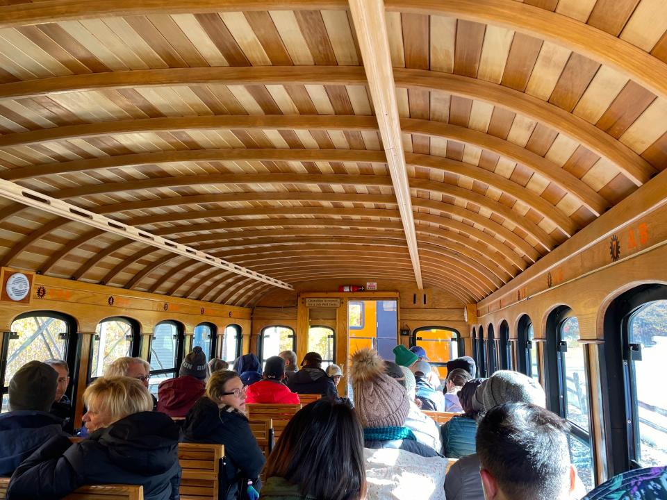 Shot of crowded train's wooden interior