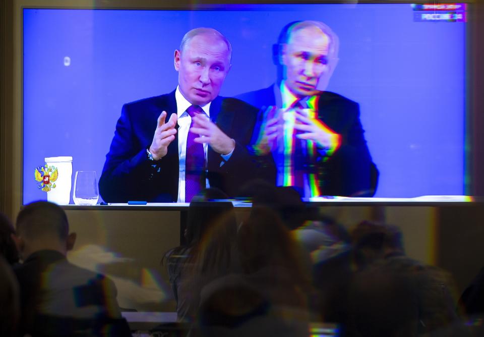 A screen showing Russian President Vladimir Putin as he answers a question during his annual call-in show in Moscow, Russia, Thursday, June 20, 2019. Putin hosts call-in shows every year, which typically provides a platform for ordinary Russians to appeal to the president on issues ranging from foreign policy to housing and utilities. (AP Photo/Alexander Zemlianichenko)