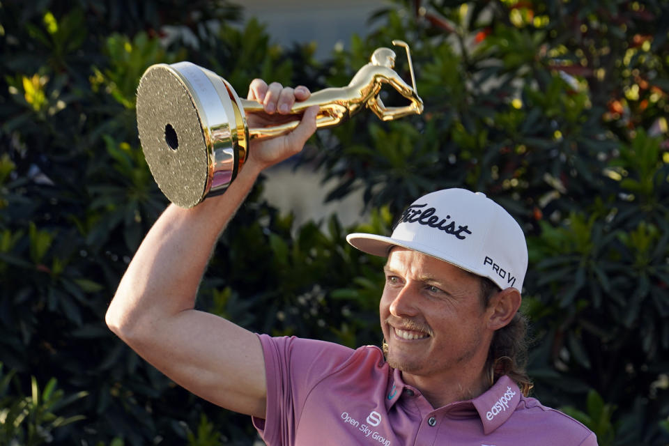 Cameron Smith, of Australia, holds the trophy after winning The Players Championship golf tournament Monday, March 14, 2022, in Ponte Vedra Beach, Fla. (AP Photo/Gerald Herbert)