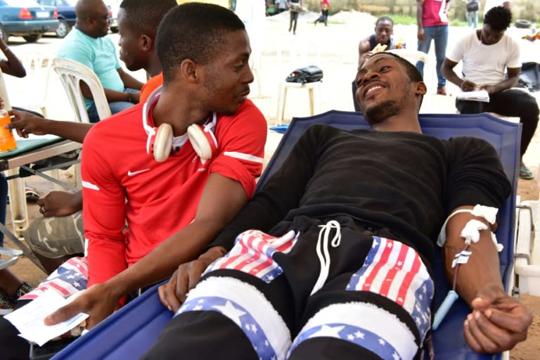 Twin brothers Romeo and Romain Guioho take part in a blood donation drive