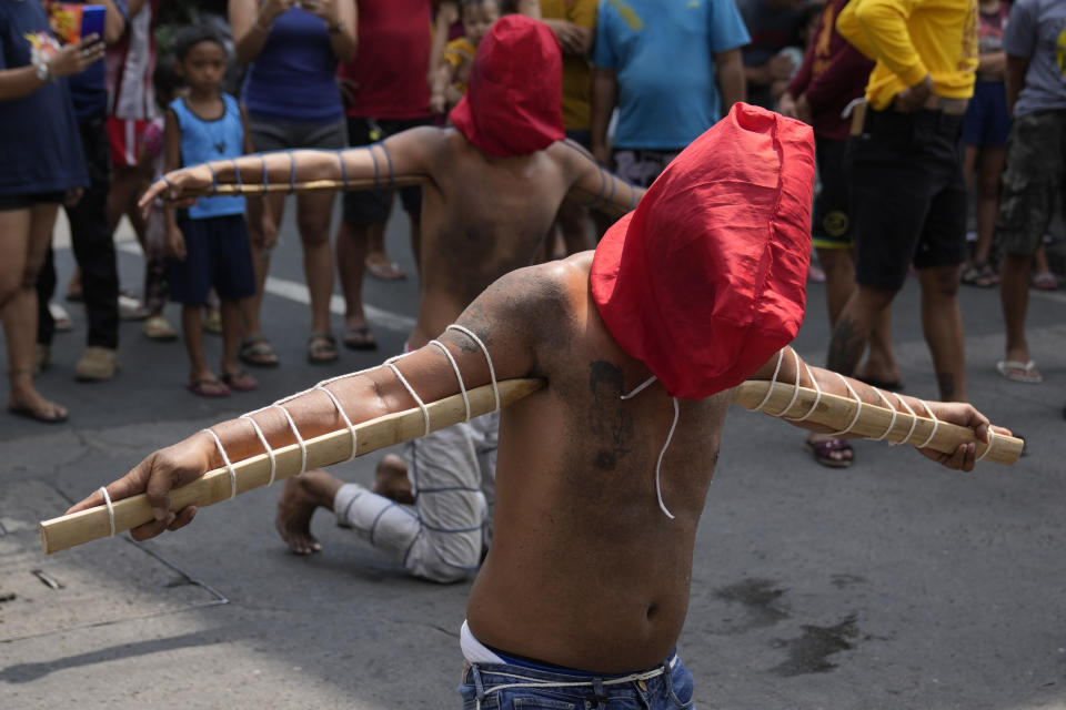 Hooded Filipino penitents carry pointed bamboo sticks as part of Maundy Thursday rituals to atone for sins or fulfill vows for an answered prayer on April 6, 2023 at Mandaluyong city, Philippines. COVID restrictions the past years have prevented crowds and devotees in participating in bizarre lenten rituals, a practice which have been opposed by the church in this predominantly Roman Catholic country. (AP Photo/Aaron Favila)