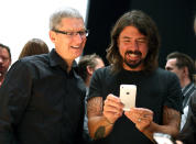 SAN FRANCISCO, CA - SEPTEMBER 12: Apple CEO Tim Cook (L) and Dave Grohl of the Foo Fighters look at the new iPhone 5 during an Apple special event at the Yerba Buena Center for the Arts on September 12, 2012 in San Francisco, California. Apple announced the iPhone 5, the latest version of the popular smart phone. (Photo by Justin Sullivan/Getty Images)