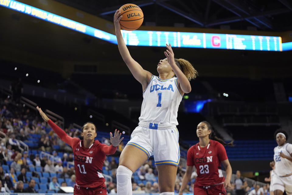 UCLA guard Kiki Rice, center, shoots as Cal State Northridge forward Olivia Smith, left, and forward Talo Li-Uperesa defend during the first half of an NCAA college basketball game Thursday, Dec. 7, 2023, in Los Angeles. (AP Photo/Mark J. Terrill)