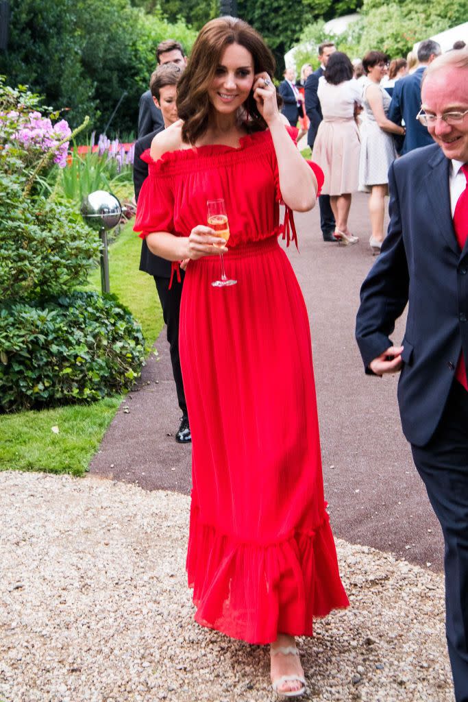 <p><em>July 19, 2017</em> — The Duchess wore a red Alexander McQueen off-the-shoulder gown at a garden party in Berlin in honor of the Queen's birthday. For accessories, Kate choose Simone Rocha drop earrings and beige <a href="https://shop.nordstrom.com/s/prada-quarter-strap-platform-sandal-women-nordstrom-exclusive/4979065/lite" rel="nofollow noopener" target="_blank" data-ylk="slk:Prada heels;elm:context_link;itc:0;sec:content-canvas" class="link ">Prada heels</a>.</p>
