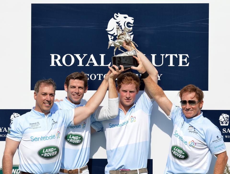 (left to right) Michael Carrazza, Malcolm Borwick, Prince Harry and Marc Ganzi, lift the winners trophy following the Sentebale Royal Salute Polo Cup, where Prince Harry scored the winning goal (Getty Images)