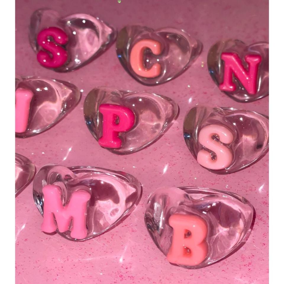 pink and clear resin rings with letters in center