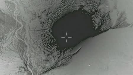 FILE PHOTO: Still image taken from a video released by the U.S. Department of Defense on April 14, 2017 shows the moment a MOAB, or "mother of all bombs", struck the Achin district of the eastern province of Nangarhar, Afghanistan, bordering Pakistan where U.S. officials said a network of tunnels and caves was being used by militants linked to Islamic State. U.S. Department of Defense/Handout via REUTERS/File Photo