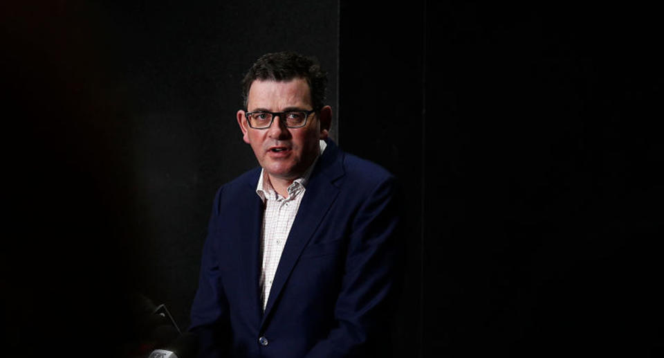 Daniel Andrews pictured with a black backdrop