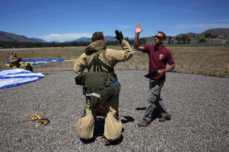 Smokejumpers celebrate a successful training jump at the North Cascades Smokejumper Base in Winthrop, Washington, U.S., June 6, 2016. REUTERS/David Ryder