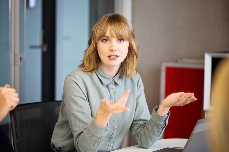 a woman talking to people at work