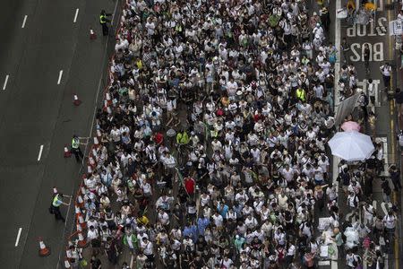 Thousands of pro-democracy protesters gather to march in the streets to demand universal suffrage in Hong Kong July 1, 2014. Tens of thousands of pro-democracy protesters marched in Hong Kong on Tuesday, with many calling for the city's leader to be sacked, in what could turn out to be the biggest and most passionate challenge to Chinese Communist Party rule in more than a decade. REUTERS/Tyrone Siu (CHINA - Tags: POLITICS CIVIL UNREST)