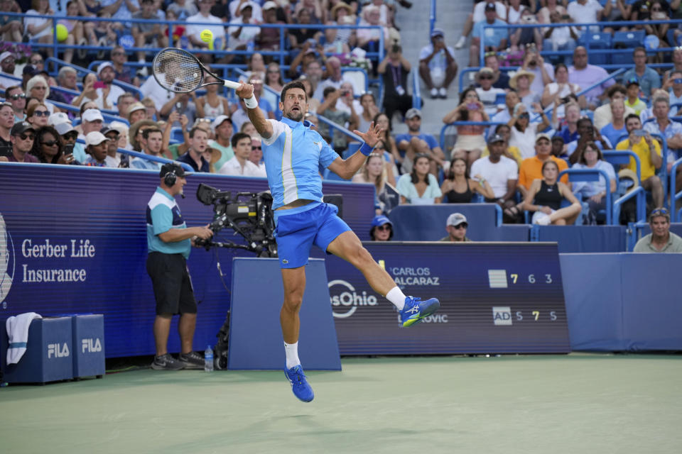 Novak Djokovic, of Serbia, returns a shot to Carlos Alcaraz, of Spain, during the men's singles final of the Western & Southern Open tennis tournament, Sunday, Aug. 20, 2023, in Mason, Ohio. (AP Photo/Aaron Doster)