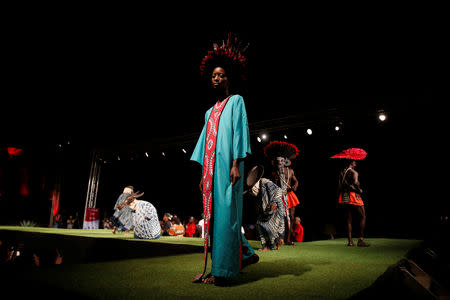 A model walks on a catwalk during a fashion show featuring African fashion and culture as part of a gala marking the launch of a book called "African Twilight: The Vanishing Rituals and Ceremonies of the African Continent" at the African Heritage House in Nairobi, Kenya March 3, 2019. REUTERS/Baz Ratner