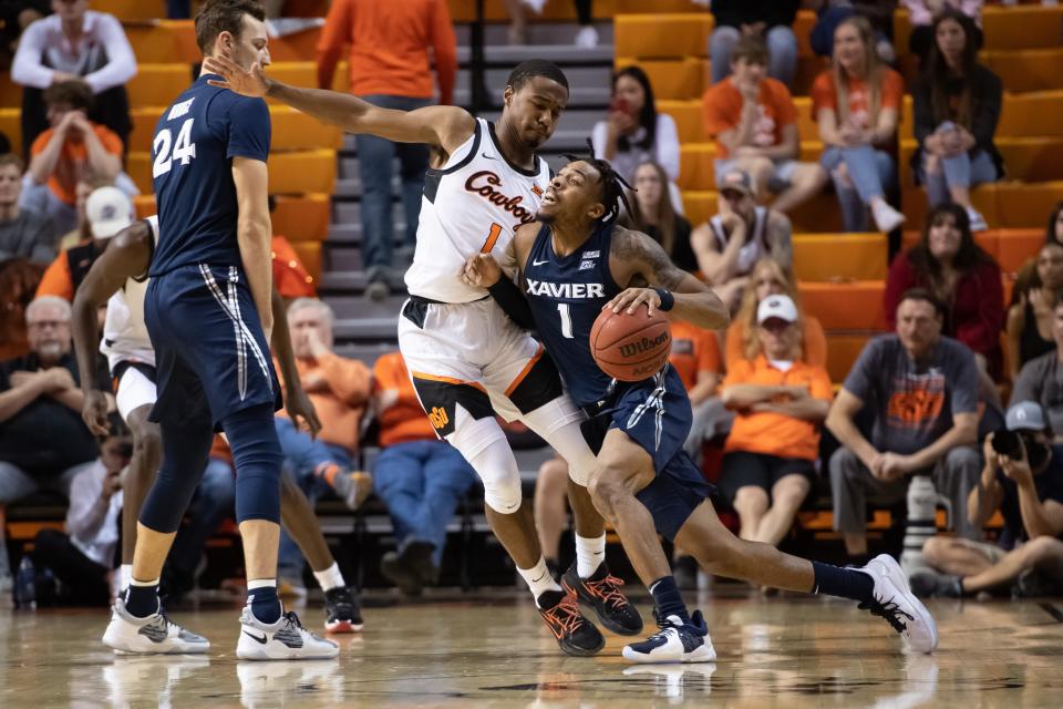 Dec 5, 2021; Stillwater, Oklahoma, USA; Xavier Musketeers guard Paul Scruggs (1) fights for position against Oklahoma State Cowboys guard Bryce Thompson (1) during the first half at Gallagher-Iba Arena.