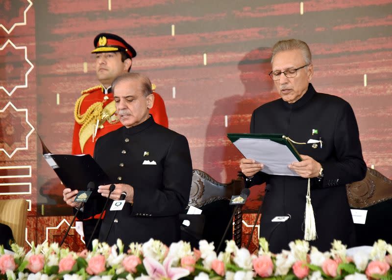 Pakistan's President Arif Alvi administers the oath to Pakistan's newly elected Prime Minister Shehbaz Sharif, in Islamabad