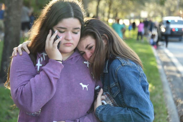 Students console each other after the shooting, which took place on Valentine's Day