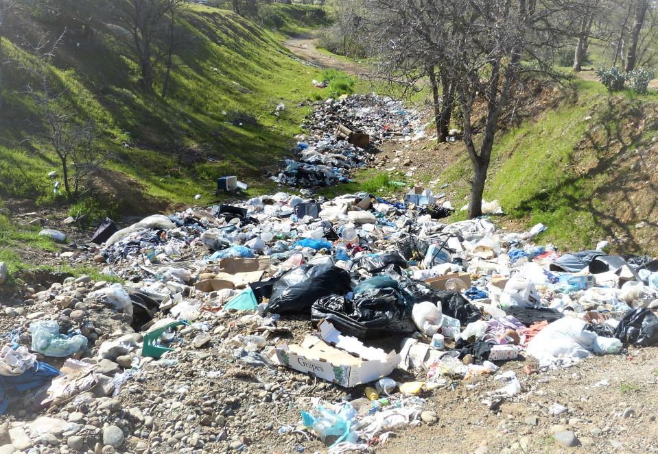 Trash fills a gully in the Sulphur Creek Canyon in Redding on Aprii 5, 2023.