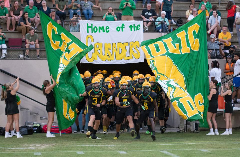 The Crusaders take the field for the Tate vs Catholic varsity Kickoff Classic football game at Pensacola Catholic High School in Pensacola on Friday, Aug. 19, 2022.