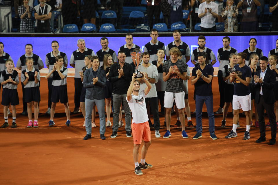 Dominic Thiem (Front) of Austria celebrates by raising the trophy after winning the final match against Filip Krajinovic of Serbia at the Adria Tour charity exhibition hosted by Novak Djokovic on June 14, 2020, in Belgrade, Serbia.