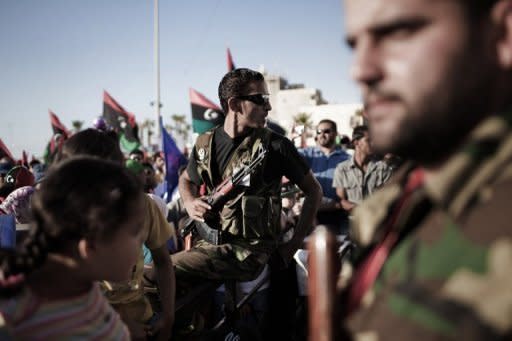 Libyan rebels keep watch as people gather for a ceremony in honour of air force officers killed during the Libyan uprising, in Benghazi on June 15. Moamer Kadhafi's regime told visiting Russian envoy Mikhail Margelov that the embattled Libyan leader is "not ready" to go, despite growing calls for him to quit and a months-long uprising