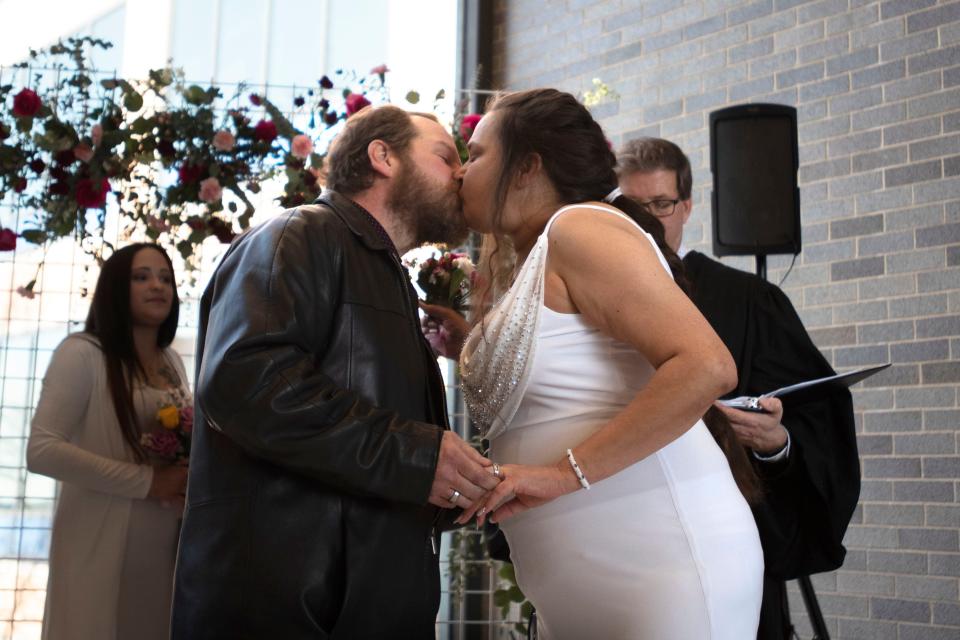 Newly weds Eric Cline, left, and Cara Melchione kisses after taking their vows during the Vows and Valentine's ceremony at Bucks County court building in Doylestown on Monday, Feb. 14, 2022. 